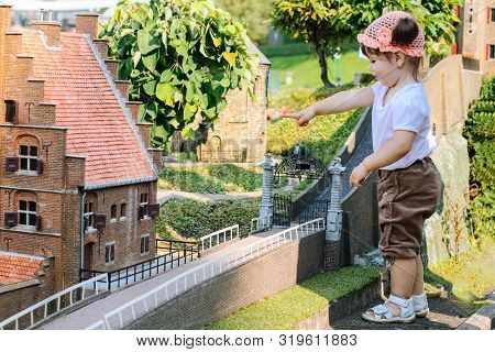Netherlands. Den Haag. Miniature Park Madurodam. August 2010. Little Girl To Point With A Finger Som