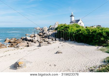 Scenic View Of Beach And Lighthouse In Brittany