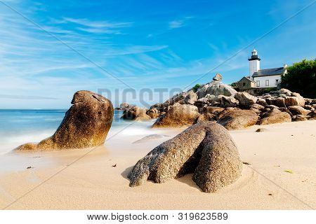 Scenic View Of Beach And Lighthouse In Brittany