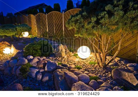Home Garden At Night, Illuminated By Globe Shaped Lights