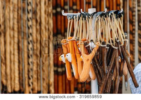Wooden Slingshot With A Stretched Rubber Band. Slingshot Is Ready To Fire