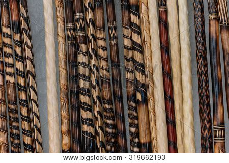Close Up Of Wooden Canes Decorated With Several Designs