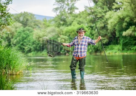 F For Fishing. Hobby And Sport Activity. Pothunter. Fisherman With Fishing Rod. Mature Man Fly Fishi