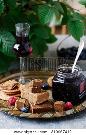 Norwegian Cheese Brunost On The Cutting Board .style Rustic.selective Focus