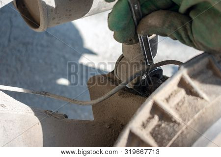 Hands In Defense Gloves Mechanics To Repair The Suspension On The Car. Work With A Wrench. Self-repa