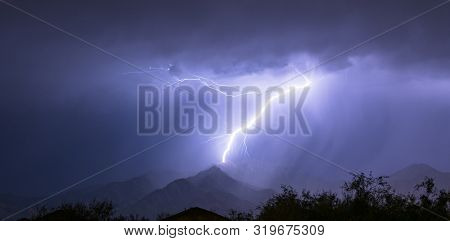 Summer Electrical Storm Produces A Lightning Bolt Illuminating A Valley In Rural Arizona