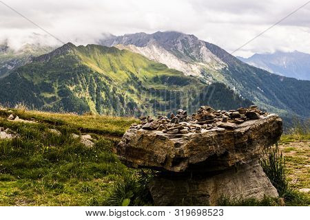 Photo Of Passo Rombo On A Gloomy Day In August With River Meadows, Pines, Pebbles And Breathtaking V