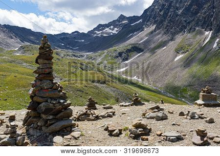 Photo Of Passo Rombo On A Gloomy Day In August With River Meadows, Pines, Pebbles And Breathtaking V
