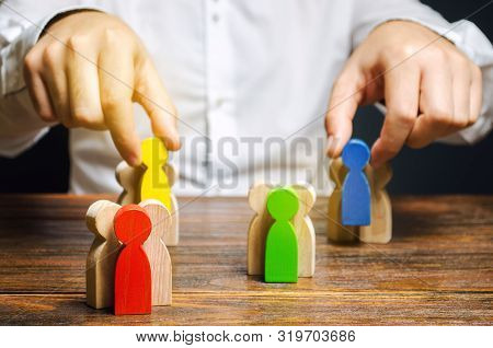 Groups Of Multicolored Wooden People And Businessman. The Concept Of Market Segmentation. Target Aud