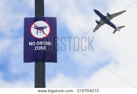 No Drones Allowed Sign With Flying Airplane In Blue Sky Which Require Registration