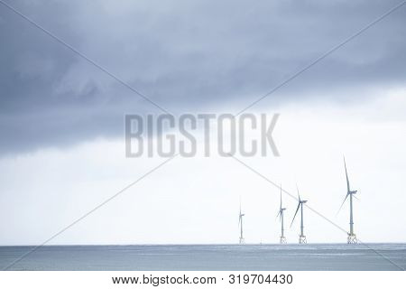 Wind Turbines At Electric Power Farm In The North Sea In Aberdeen For Renewable Energy Production An