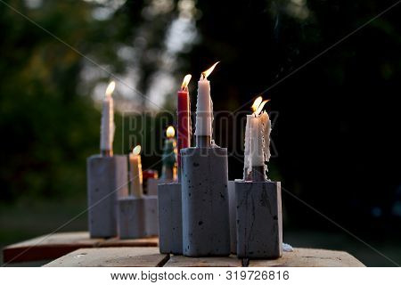 Candles Burning In The Breeze In The Summer Evening