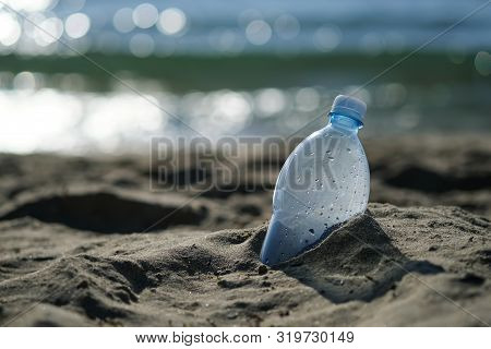 Plastic Bottle Is On The Beach Leave By Tourist. The Problem Of Pollution Of The Waters Of The Ocean