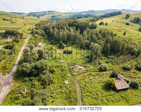 Aerial Top View Of A Settlement In The Altai Mountains With Small Houses For Indigenous People And T