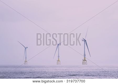 Wind Turbines At Electric Power Farm In The North Sea In Aberdeen For Renewable Energy Production An