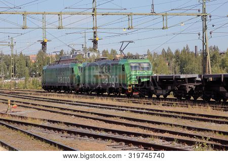 Lulea, Sweden - August 20, 2019: Two Green Cargo Electric Locomitives Class Re Pulling Flat Wagons L