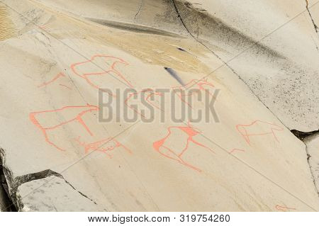Rock Art In Alta Fjord, Norway. Ancient Symbols, Real Drawing,  Texture In Stone. Red Ocher Paint. H