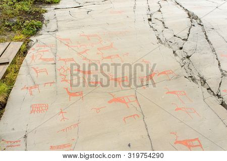 Rock Art In Alta Fjord, Norway. Ancient Symbols, Real Drawing,  Texture In Stone. Red Ocher Paint. H