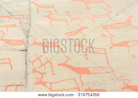 Rock Art In Alta Fjord, Norway. Ancient Symbols, Real Drawing,  Texture In Stone. Red Ocher Paint. H