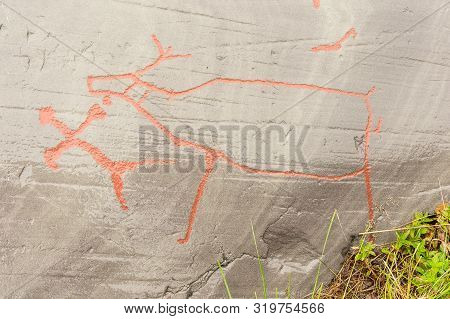 Rock Art In Alta Fjord, Norway. Ancient Symbols, Real Drawing,  Texture In Stone. Red Ocher Paint. H