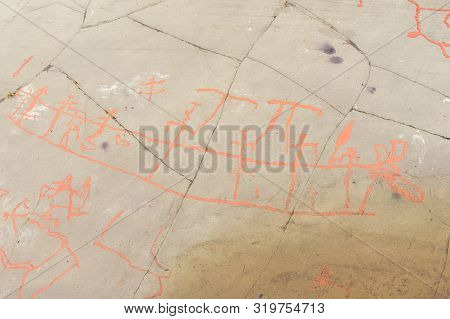 Rock Art In Alta Fjord, Norway. Ancient Symbols, Real Drawing,  Texture In Stone. Red Ocher Paint. H