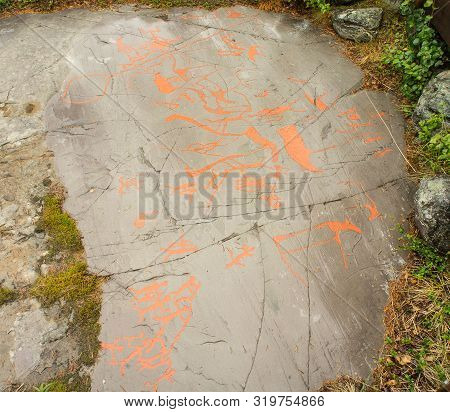 Rock Art In Alta Fjord, Norway. Ancient Symbols, Real Drawing,  Texture In Stone. Red Ocher Paint. H