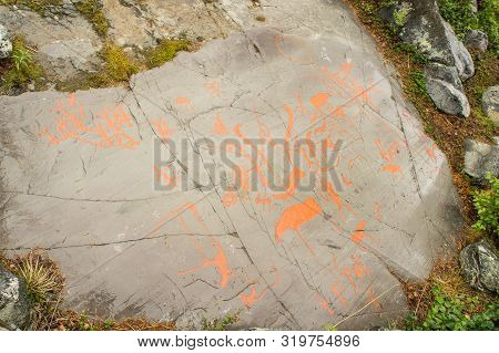 Rock Art In Alta Fjord, Norway. Ancient Symbols, Real Drawing,  Texture In Stone. Red Ocher Paint. H