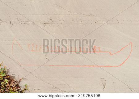 Rock Art In Alta Fjord, Norway. Ancient Symbols, Real Drawing,  Texture In Stone. Red Ocher Paint. H
