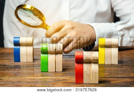Groups Of Multicolored Wooden People And Businessman. The Concept Of Market Segmentation. Target Aud