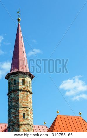 The Tower With The Spire And The Red Roofs Of The Maltese Style Adobe Mansion On The Sunlit Backgrou