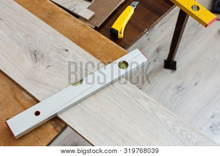 Installation Laminate Or Parquet In The Room, Worker Installing Wooden Laminate Flooring, Marking Th