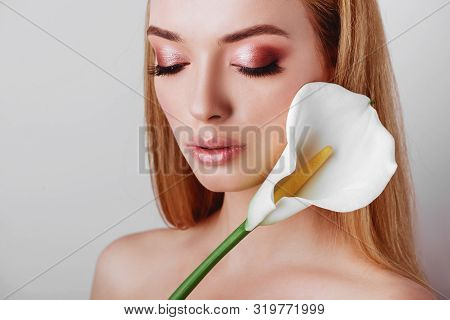 Portrait Of Happy Young Redhead Lady Looking Out Of White Flowers Studio Shot