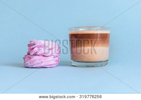Mini Cup Of Multilayer Coffee In A Glass Cup On Blue Background