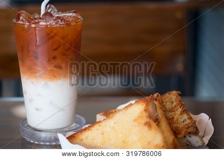 Garlic Bread In White Paper Tray Served With Thai Milk Tea In The Breakfast