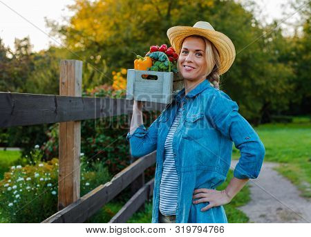 Young 30-35 Years Old Beautiful Woman Farmer Hat With Box Fresh Ecological Vegetables Garden Backgro