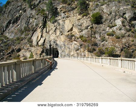 Pathway Along The Dam Leading To A Cave And Then Hiking Paths.