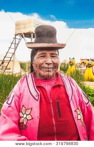 Uros, Peru- Jan 5, 2019: Portrait  of woman with hat from  Uros floating islands, Titicaca lake, Peru.
