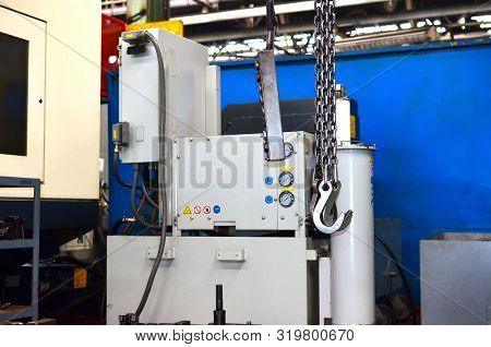 Crane Hook Of The Overhead Crane In The Workshop Of An Industrial Plant.  Push Remote Control Switch