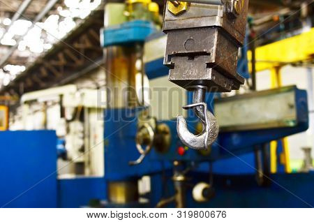Crane Hook Of The Overhead Crane In The Workshop Of An Industrial Plant.  Push Remote Control Switch
