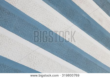 Diagonal View Of Blue And White Parget Striped Wall Background. Sharp Surface