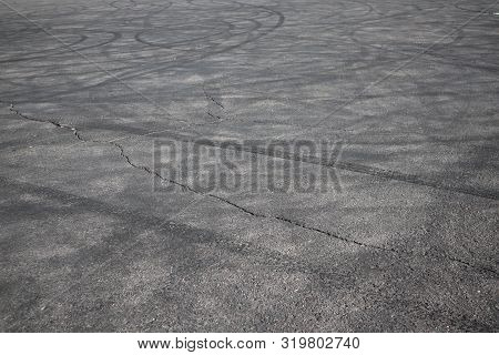 Tire Tracks. Wheel Track On Asphalt Road. Asphalt With Traces Of Car Wheels. Traces Of Braking From 