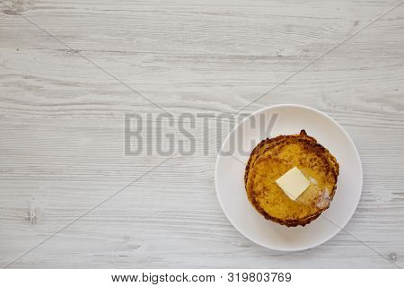 Homemade Corn Meal Johnny Cakes With Butter On A White Plate Over White Wooden Background, Top View.