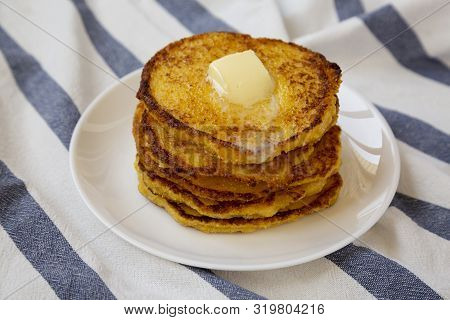 Homemade Corn Meal Johnny Cakes With Butter On A White Plate, Side View. Close-up.