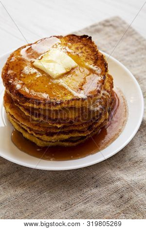 Homemade Cornmeal Johnnycakes With Butter And Maple Syrup On A White Plate, Low Angle View. Close-up