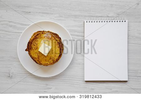 Homemade Corn Meal Johnny Cakes With Butter On A White Plate, Blank Notebook On A White Wooden Backg
