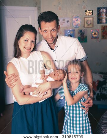 Concept Of Family Happiness - Daddy, Daughter And Mom With A Newb