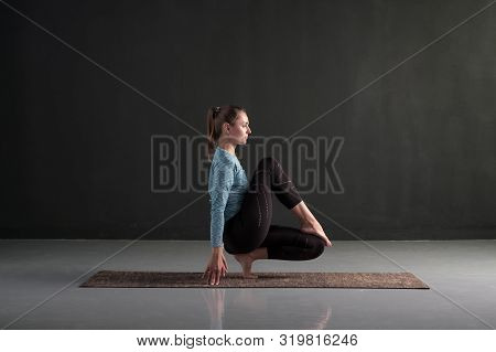 Young Girl Practicing Yoga Standing In Toe Balance Exercise Or Toestand Pose