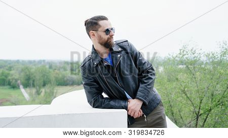 Side View Fashion Portrait Of Thinking Stylish Young Handsome Bearded Hipster Man In Sunglasses Look