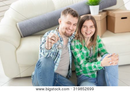 Young Married Couple With Boxes And Holding Flat Keys.