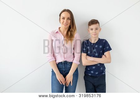 Good-looking Single-parent Mom And Teen Son On White Background. Cohesion, Friendship And Family Rel
